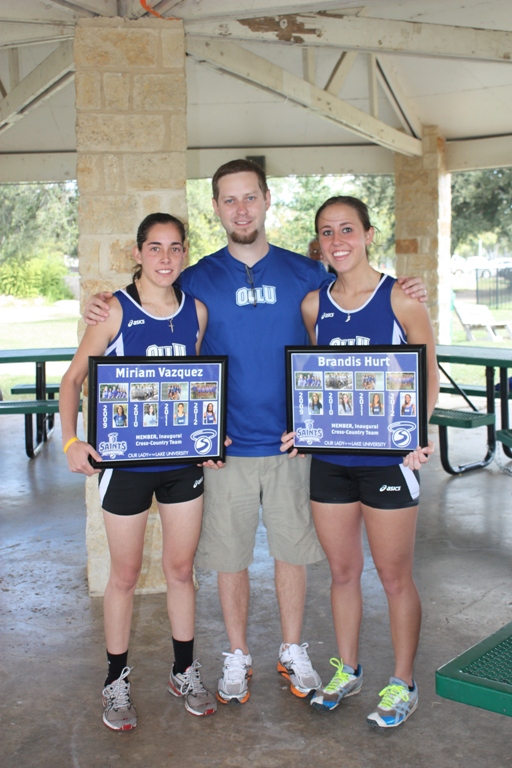 Coach Stephen Sherman presented a photo collage to seniors Miriam Vazquez and Brandis Hurt.