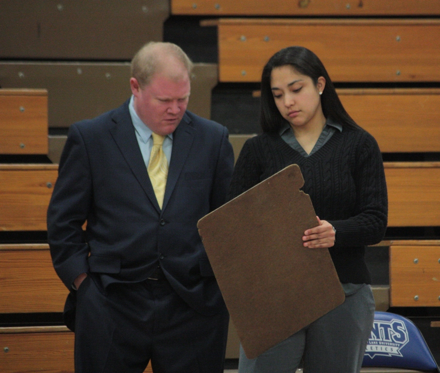 Coach Minner and Coach Huizar go over a play during the Texas A&M International game.